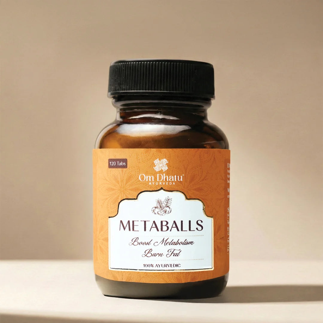 Omdhatu Ayurvedic Metaballs in a glass jar, a potent herbal formulation for metabolism and digestive health