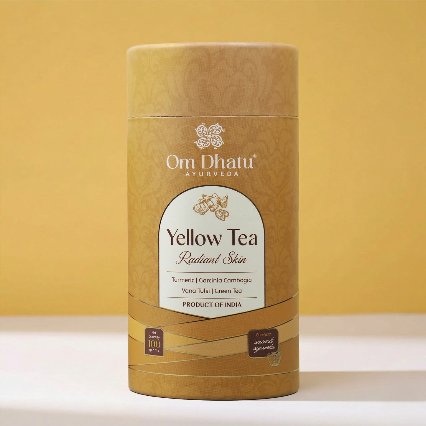 A warm, glowing cup of Yellow Tea next to the Omdhatu can, emphasizing a bright, refreshing morning wellness ritual.